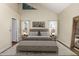 Serene bedroom with vaulted ceilings, soft lighting, and a large window overlooking the neighborhood at 5021 W Chicago N Cir, Chandler, AZ 85226