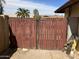 Private backyard secured by tall metal gates, enhancing security and providing privacy at 5323 W Seldon Ln, Glendale, AZ 85302