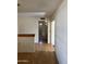 Hallway view showcasing hardwood flooring, light walls and ceiling, and doorways leading to various rooms at 5323 W Seldon Ln, Glendale, AZ 85302