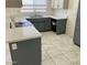 Well lit kitchen with bright counter tops, stainless steel appliances, and ceramic tile floors at 5323 W Seldon Ln, Glendale, AZ 85302