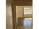 Sunlit living room with hardwood floors, a large window, and a glimpse of the outdoor backyard at 5323 W Seldon Ln, Glendale, AZ 85302