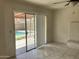 View of the living room with sliding glass doors leading to an outdoor pool area at 5323 W Seldon Ln, Glendale, AZ 85302