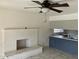 Living room featuring a white brick fireplace and a partial view of the kitchen at 5323 W Seldon Ln, Glendale, AZ 85302