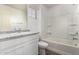 Well-lit bathroom with a granite countertop vanity and a shower-tub combo at 5474 W Fulton St, Phoenix, AZ 85043