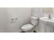 Cozy half-bathroom with a modern toilet and stylish pedestal sink at 5474 W Fulton St, Phoenix, AZ 85043