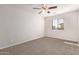 Neutral bedroom featuring carpet, ceiling fan, and a window allowing natural light at 5474 W Fulton St, Phoenix, AZ 85043