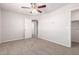 Spacious bedroom showcasing neutral walls, carpet flooring and a door to another room at 5474 W Fulton St, Phoenix, AZ 85043