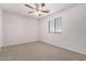 Neutral bedroom featuring carpet, ceiling fan, and a window allowing natural light at 5474 W Fulton St, Phoenix, AZ 85043