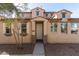 Charming two-story home featuring a beautiful stucco exterior, arched entry and well-manicured landscaping at 5474 W Fulton St, Phoenix, AZ 85043