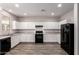 Spacious kitchen features white cabinetry, granite countertops, and black appliances at 5474 W Fulton St, Phoenix, AZ 85043