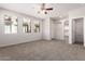 Spacious living room featuring neutral walls and carpet, large windows and an open floor plan at 5474 W Fulton St, Phoenix, AZ 85043