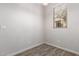 Small room featuring neutral walls, light gray wood-look floors and a window at 5474 W Fulton St, Phoenix, AZ 85043