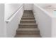 Carpeted staircase with white railing, providing a safe and comfortable transition between levels at 5474 W Fulton St, Phoenix, AZ 85043