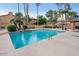 Serene community pool with lush tropical landscaping and convenient lounge chairs at 5640 E Bell Rd # 1081, Scottsdale, AZ 85254