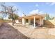 Inviting backyard patio with covered seating area, mature trees, and private block fence, perfect for outdoor entertaining at 5951 E Inglewood St, Mesa, AZ 85205