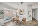 Bright dining room with modern light fixture, window seat, and decorative shelving at 5951 E Inglewood St, Mesa, AZ 85205