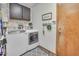 Functional laundry room with modern washer and dryer, cabinets and a door to the outside at 5951 E Inglewood St, Mesa, AZ 85205