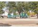 Community playground with colorful climbing structures, swings, and ample green space for children to play and explore at 5951 E Inglewood St, Mesa, AZ 85205