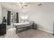 Bedroom with a decorative lamp, arched window, and a comfortable bed frame with a ceiling fan at 627 W Flower Ave, Mesa, AZ 85210