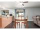 Cozy dining area open to the kitchen, featuring wood floors and natural light at 627 W Flower Ave, Mesa, AZ 85210