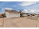 This home features solar panels, a 2-car garage, a rock yard, and a blue front door at 627 W Flower Ave, Mesa, AZ 85210