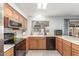 Well-lit kitchen with wood cabinets, laminate countertops, and modern appliances at 627 W Flower Ave, Mesa, AZ 85210