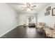 Inviting living room with wood floors, neutral walls, and a large bright window at 627 W Flower Ave, Mesa, AZ 85210