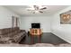 Spacious living room boasting wood floors, neutral paint, ceiling fan, and plenty of light at 627 W Flower Ave, Mesa, AZ 85210