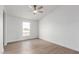 A sun-filled bedroom with great natural light and wood-look flooring at 6901 W Patricia Ann Ln, Peoria, AZ 85382