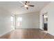 Bright bedroom featuring a ceiling fan, wood-look flooring, and natural light through windows at 6901 W Patricia Ann Ln, Peoria, AZ 85382