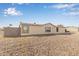 Beige one-story home in a desert landscape, under a beautiful blue sky with scattered clouds at 6901 W Patricia Ann Ln, Peoria, AZ 85382