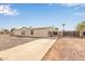 Charming single-story home with desert landscape, featuring a long driveway leading to a gated entrance at 6901 W Patricia Ann Ln, Peoria, AZ 85382