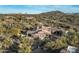 Stunning aerial view of a luxury home showcasing its tile roof and desert landscaping with mountain views at 7363 E Lower Wash Pass, Scottsdale, AZ 85266