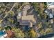 Overhead view of an estate with tile roof, pool and landscaping and desert vegetation at 7363 E Lower Wash Pass, Scottsdale, AZ 85266