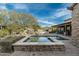 Expansive backyard with a sparkling pool, spa, and lush greenery, providing an idyllic setting for outdoor entertainment at 7363 E Lower Wash Pass, Scottsdale, AZ 85266