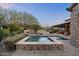 Relaxing backyard with a pool, spa, patio, and desert plants creating a private oasis at 7363 E Lower Wash Pass, Scottsdale, AZ 85266