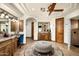 Large primary bathroom with dual vanities, an oval ottoman, and glass block shower at 7363 E Lower Wash Pass, Scottsdale, AZ 85266