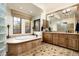 Luxurious bathroom features a soaking tub, vanity with double sinks, and lots of natural light at 7363 E Lower Wash Pass, Scottsdale, AZ 85266