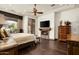 Spacious bedroom featuring a fireplace, television, and French doors leading to the outside at 7363 E Lower Wash Pass, Scottsdale, AZ 85266