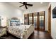 Comfortable bedroom featuring a decorative bed frame and doors to the outdoor living space at 7363 E Lower Wash Pass, Scottsdale, AZ 85266