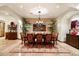 Formal dining room featuring a large wooden table, upholstered chairs, and elegant chandelier on patterned rug at 7363 E Lower Wash Pass, Scottsdale, AZ 85266