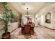 Formal dining room featuring a large wooden table, upholstered chairs, and elegant chandelier at 7363 E Lower Wash Pass, Scottsdale, AZ 85266