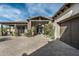 Welcoming entrance with stone accents, a covered entry, and lush landscaping for added curb appeal at 7363 E Lower Wash Pass, Scottsdale, AZ 85266