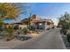 Stunning exterior features desert landscaping, a paved driveway, and a welcoming entrance to the house at 7363 E Lower Wash Pass, Scottsdale, AZ 85266