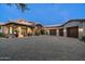 Elegant home showcasing a circular driveway and a three-car garage, perfect for car enthusiasts at 7363 E Lower Wash Pass, Scottsdale, AZ 85266