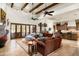 Open-concept living room with high ceilings, exposed wood beams, and seamless access to the kitchen at 7363 E Lower Wash Pass, Scottsdale, AZ 85266