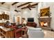 Bright living room with a stone fireplace, beamed ceilings, and comfortable furniture at 7363 E Lower Wash Pass, Scottsdale, AZ 85266