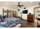 Bright main bedroom featuring hardwood floors, ceiling fan, and access to the outdoors at 7363 E Lower Wash Pass, Scottsdale, AZ 85266