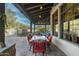 Spacious covered patio with elegant dining setup, perfect for enjoying meals outdoors with scenic views of the backyard at 7363 E Lower Wash Pass, Scottsdale, AZ 85266