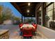 Outdoor dining area on a covered patio with a stone table and seating for eight at 7363 E Lower Wash Pass, Scottsdale, AZ 85266